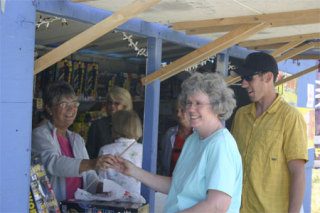 Michael and Mary Frost of Coupeville purchase their pyrotechnics from Soroptomist Susan Sehlin at the Soroptomists International of Oak Harbor fireworks stand on Highway 20 near 7-Eleven.