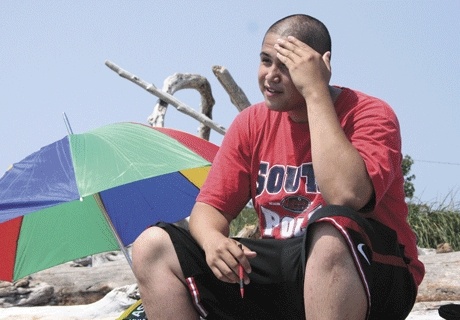 Laurence Edens wipes the sweat from his forehead at Windjammer Park during the peak-high temperatures