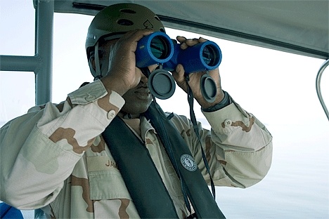 Carl James peers through a pair of binoculars to get a better look at the Coast Guard Auxiliary boat mid-way through the training exercise Thursday.