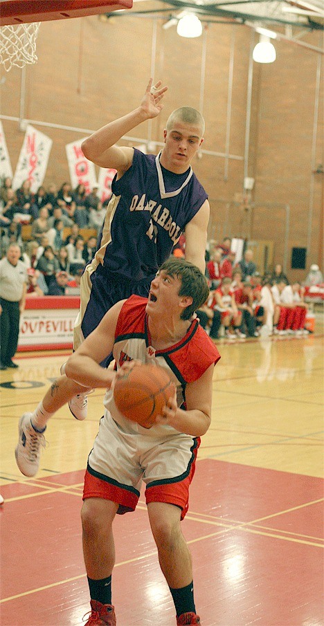 A Hunter Hammer fake gets Aaron Boesch off the ground as the Coupeville post  powers up for two of his 24 points.