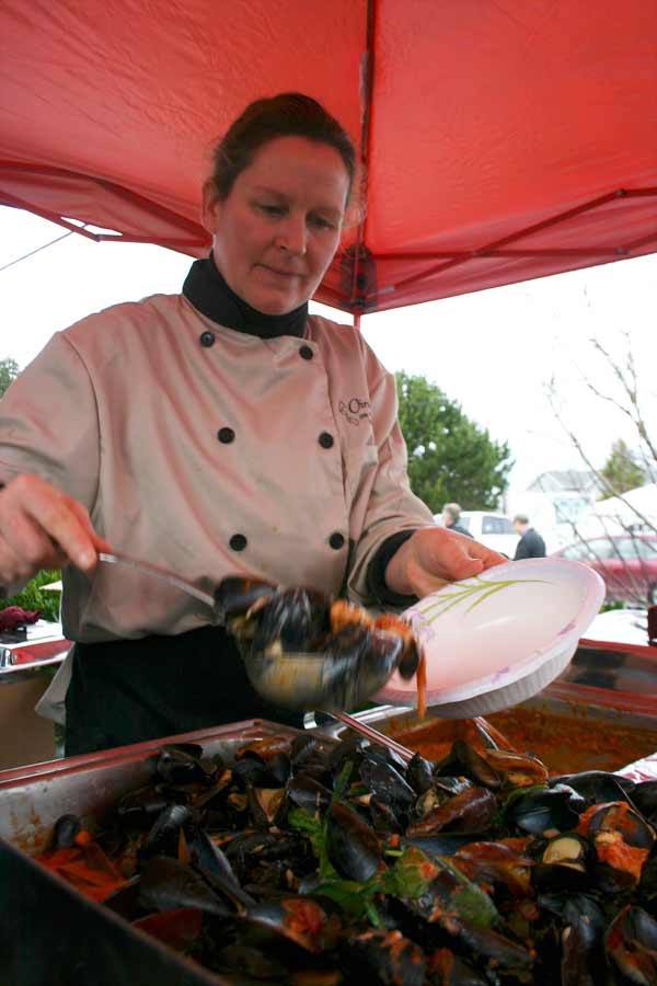 Christy Reid of Christopher’s Cafe readies the restaurant’s smoked salmon and mussels during the Penn Cove Mussel Festival.