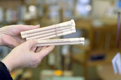 Lydia Sikes holds out a handful of mason bee tubes. The friendly