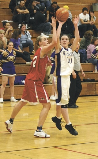 Oak Harbor’s Kathryn Fisken gets her scoring attempt swatted away by Snohomish forward Katie Benson.