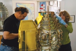 Nick Johnston and Kim Fahlen work on restoring the Fresnel lens at Admiralty Head Lighthouse.