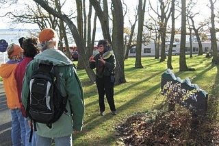 Naturalist Melissa Duffy instructs Meet Feet tour-takers on the natural wonders of Oak Harbor’s Smith Park.