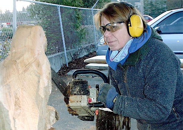 Chainsaw woodcarver Lynn Backus demonstrates and sell her art at Skagit Farmer Supply in Oak Harbor