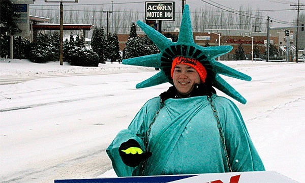 Jeanna Wilson spent a snowy Wednesday trying encourage people to go to Liberty Tax Service. Many businesses tried to stay open even though several inches of snow fell on Whidbey Island.