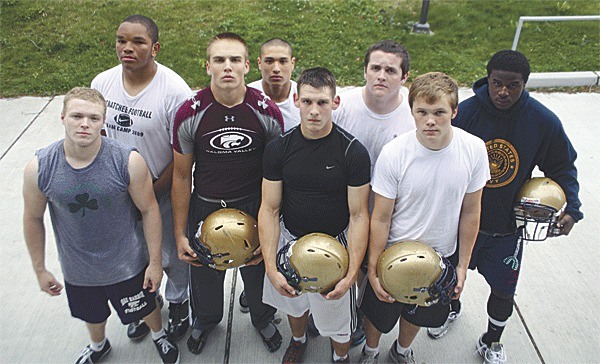 The Oak Harbor High School offensive line has helped the Wildcats lead the Western Conference in rushing this year. The players include in front (left to right)