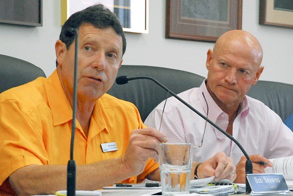 Oak Harbor City Council members Bob Severns and Rick Almberg participate in a recent meeting concerning the burying of utility lines along SE Pioneer Way. It’s been suggested that both men may have had a conflict in interest and should have recused themselves from voting on the project.