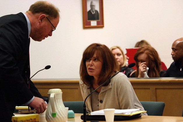 Peggy Sue Thomas talks with her attorney during her sentencing hearing Friday in Island County Superior Court.