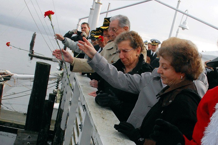 Members of Pearl Harbor Survivor’s Association Chapter Five cast flowers into Puget Sound at the Seaplane Base Wednesday during an annual remembrance ceremony.