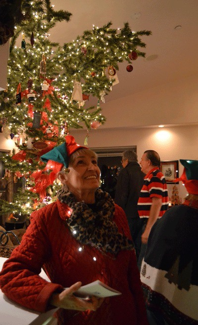 Alma Williams looks up at the decorations in Barb and Bob Jacobs’ home.