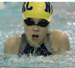 Olivia Tungate churns her way to victory in the girls 8-and-under 50 breaststroke. She won the event in a time of 47.45.