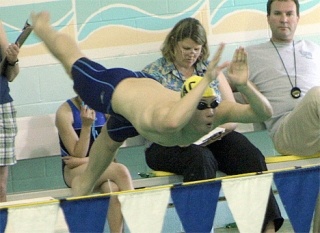 North Whidbey Aquajet John Hu explodes off the starting blocks en route to winning the 15-and-over 200 butterfly at the Spring Thunderbird Invitational in Anacortes.