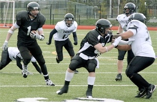 Sting wide receiver Travie McKee gets blocking help from teammate Brian Ensley to pick up a nice gain in the second quarter of Saturday’s game against the Hells Canyon Thunder. McKee scored the Sting’s second touchdown on a 52-yard reception.