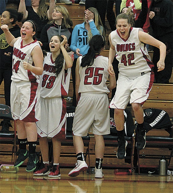 The Coupeville bench erupts at the final buzzer in the Wolves' thrilling 42-41 win over Meridian Thursday. From left