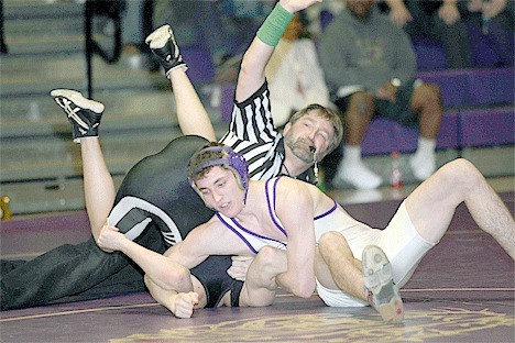 Oak Harbor senior Colton Elliot pins Cody Curnutt in the Wildcats’ 43-35 home loss to Monroe Thursday.