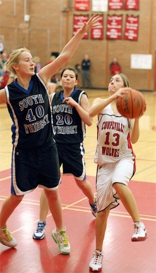 Cassidi Rosenkrance has her path to the basket blocked by South Whidbey defender Lindsey Newman.