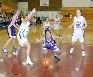 Oak Harbor’s Jessica Denmon goes all  out trying to recover a loose ball under the offensive boards in the first half of Wednesday’s district  playoff game.