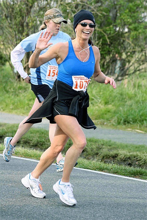 Oak Harbor’s Michelle Beck enjoying her run in the half-marathon Sunday.