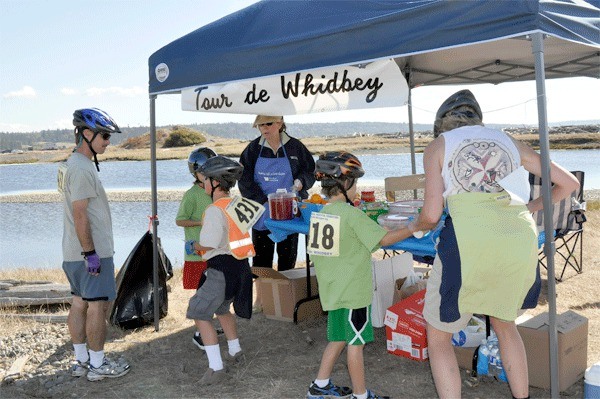 Tour de Whidbey participants from last year's event stop at a break station to refresh.