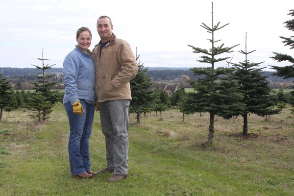 Tricia and Mike Miller stand on their 25-acre property just off Torpedo Road. The tree farm