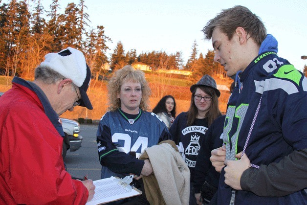 Seahawks fans prepare to board a Whidbey SeaTac Shuttle bus Wednesday morning bound for the Super Bowl parade in downtown Seattle.