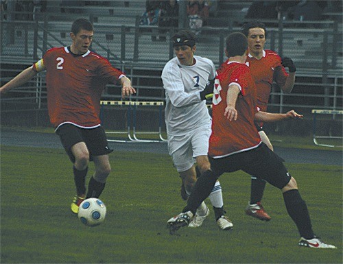 Coupeville's Taylor Phillips (2) and Nathan Lamb (8) close in on the ball in the Wolves' win over South Whidbey.