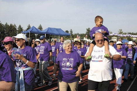 Three-year-old Ayden Watts is carried by his grandfather