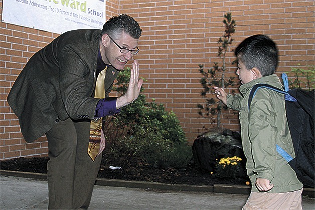 New Oak Harbor schools superintendent Lance Gibbon greets a student at Crescent Harbor Elementary School Thursday.