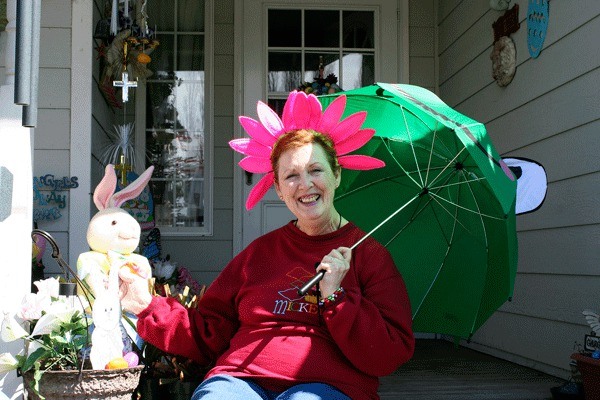 Barbara Lister sits on her front porch which she’s donned with dozens of Easter decorations. Lister decorates her Oak Harbor home for every holiday in hopes of bringing some cheer to her neighbors.