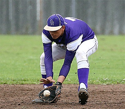 Oak Harbor shortstop Aaron Martinez looks in a ground ball.