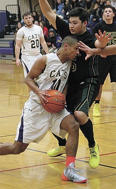 Oak Harbor's Gabe Groenig bulls by the defense of Marysville Getchell's Kody Phaysith.