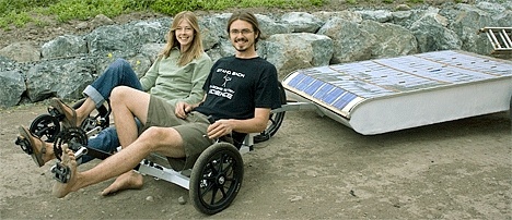 George Stelle and Beth Roberts show off their hybrid solar and pedal-powered trike.