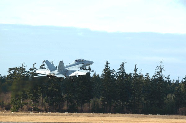 An EA-18G Growler ascends after a touch-and-go at OLF.