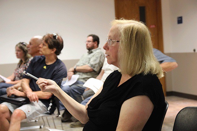 Oak Harbor resident Cheryl Louder speaks at a community meeting about Island Transit Monday evening. She relies on buses to travel to the airport.