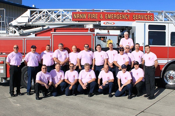 Members of Navy Region Northwest Fire and Emergency Services show off their pink T-shirts Thursday morning on NAS Whidbey Island. Firefighters wore the pink shirts all week in support of Breast Cancer Awareness month and to raise money for Susan G. Komen For the Cure.