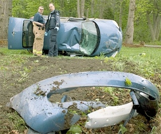 Two emergency responders survey a car wreck on E. Silver Lake Road Monday morning.