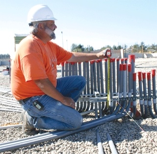 Foreman Dennis Gadbois sets up electrical components on  the new CTE building at Oak Harbor High School.