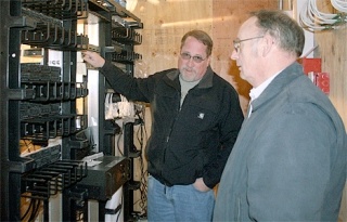 Director of Information Services Bruce Roberts and network specialist Al Swapp examine the new technology upgrades in the Career and Technical Education building.