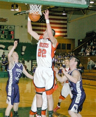 Cody Peters rips down a rebound during Saturday's game against Nooksack Valley.