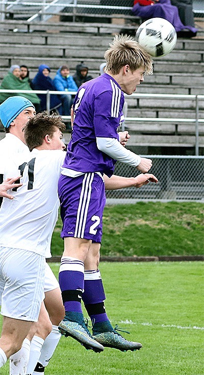 Eric Jensen heads the ball for the Wildcats in Saturday's match at Anacortes.