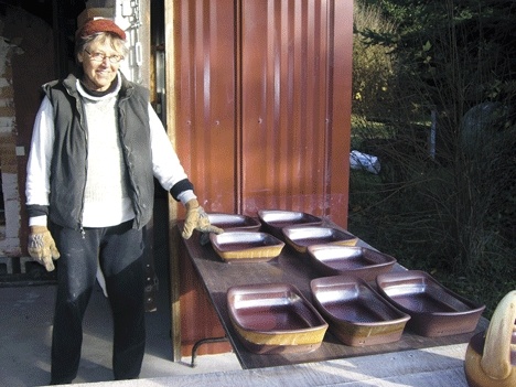 Whidbey Artist Robbie Lobell is shown here with some of her flameware pots.