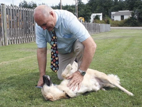 Eric Anderson with Oak Harbor’s Best Friend’s Veterinary Center plays with a dog from Iraq. The pooch needs a good home.