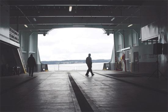 A spectator strolls down the car deck of the Salish