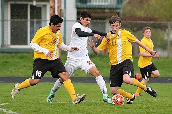 Coupeville's Abraham Leyva Elenes splits two Sequim defenders.