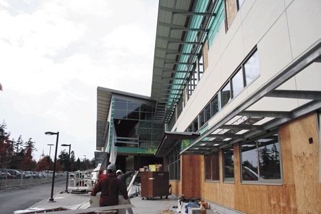 Construction crews mount siding to the exterior of the new Student Union Building
