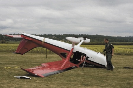 Mike Hawley with the Island County Sheriff's Office investigates a plane crash in Central Whidbey Monday afternoon.