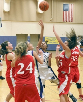 Oak Harbor’s Jessica Denmon splits Stanwood defenders Renee Lucero