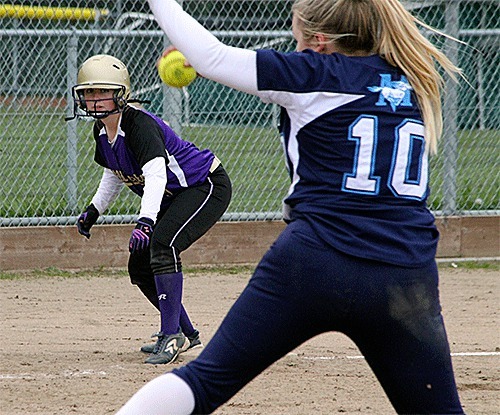 Oak Harbor's Kelly Findley waits on third base as Meadowdale's Lauren Dent fires a pitch. Findley singled earlier in the inning to help the Wildcats win 11-2.